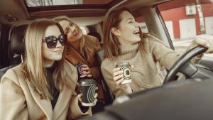 Three women drinking coffee in a car (credit: Gustavo Fring)